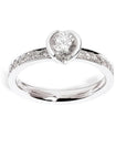 An 18ct white gold ring with a round brilliant cut diamond center stone and two round brilliant cut diamond shoulders.